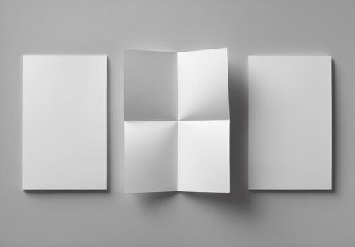 Three folded white paper brochures on a gray background photo