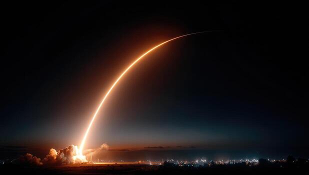 A rocket is launched into the sky at night photo