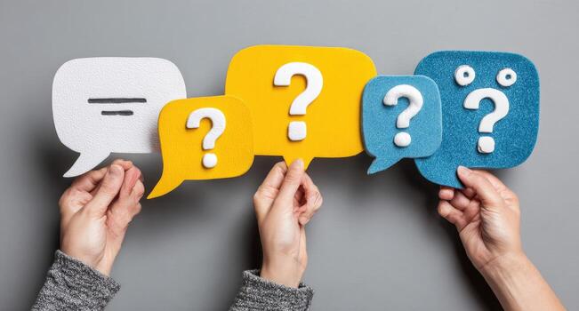 Hands holding speech bubbles with question marks photo