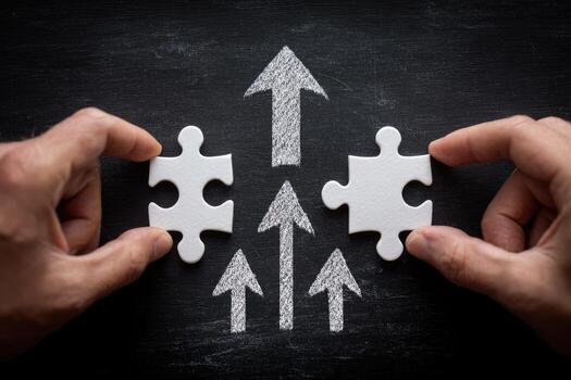 Two hands holding pieces of puzzle pieces with arrows pointing up photo