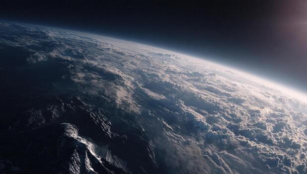 The earth from space, with the sun shining over the mountains photo