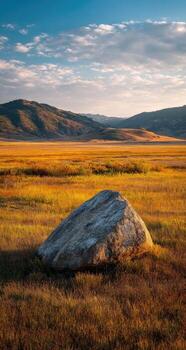 A large rock in a field photo