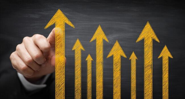Businessman pointing to arrows on blackboard photo