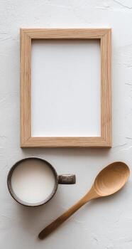 Wooden spoon and empty frame on white background photo