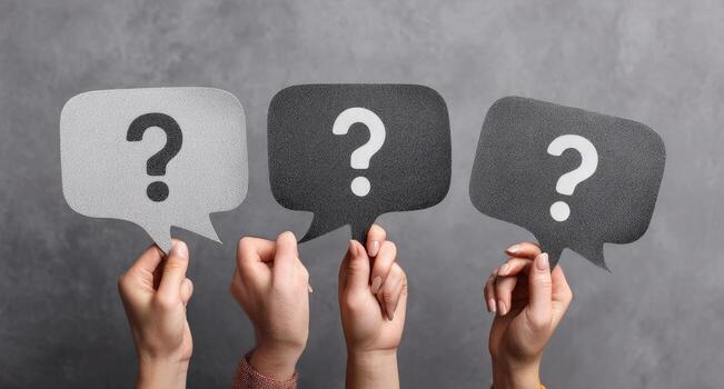 Hands holding question marks with speech bubbles photo