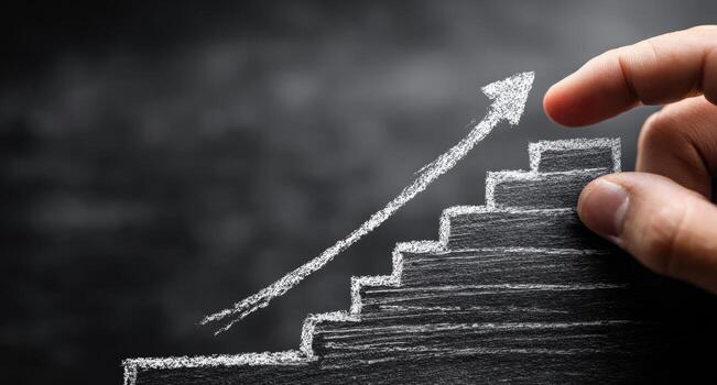 Hand drawing up a ladder with a graph going up photo