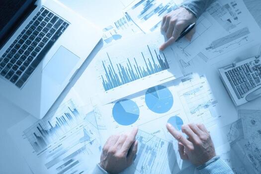 Business people working on graphs and charts photo