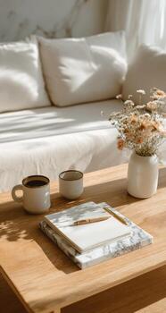 Coffee table with notebook and flowers photo