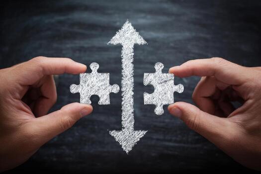Two hands holding puzzle pieces with arrows pointing to each other photo