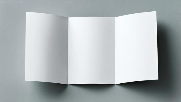 A folded white paper on a gray background photo