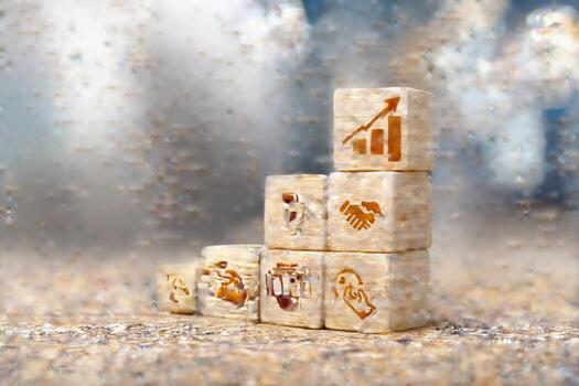 A stack of wooden cubes with business symbols on them photo