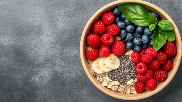Berries, blueberries, raspberries, and chia seeds in a bowl on a gray photo
