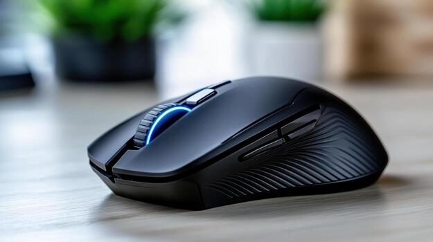 A black computer mouse sitting on a table photo