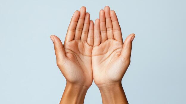 Two hands with open palms on a blue background photo