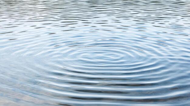 A circular pattern of ripples in a body of water photo