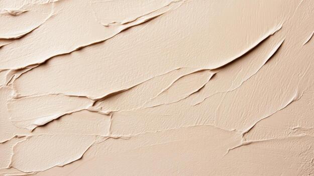 A close up of a cream colored wall with cracks photo