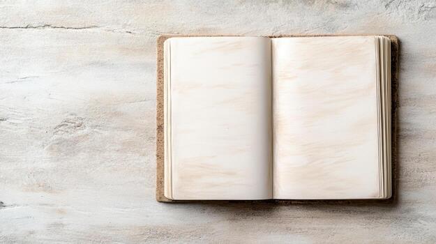 Blank sketchbook on textured surface, inviting creativity and inspiration photo