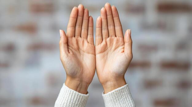 Two hands with open palms on a gray background photo