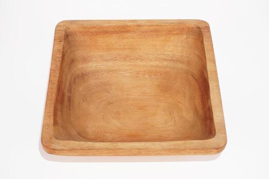 A rectangular wooden plate with a raised edge sits on a white background. photo