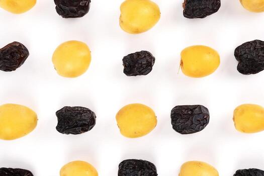 The top down view shows a clean pattern of alternating yellow young dates and ripe dates. photo