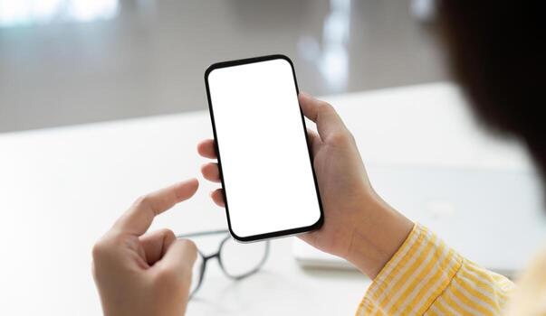 Mobile Technology. Individual interacting with smartphone displaying empty screen for app showcase. photo