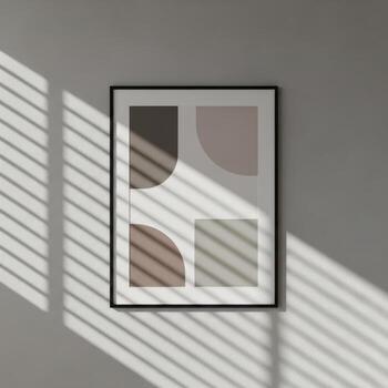 Modern abstract geometric art print featuring soft earth tones and curved shapes in a black frame isolated on white background photo