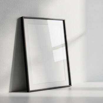 A sleek black framed picture frame leans against a wall casting subtle shadows isolated on white background photo