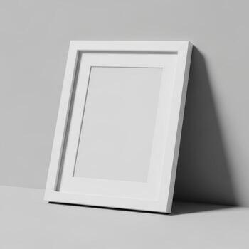 A simple white picture frame leaning against a wall showcasing its clean design isolated on white background photo
