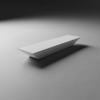 A minimalist white rectangular prism casting a subtle shadow on a textured surface isolated on white background photo