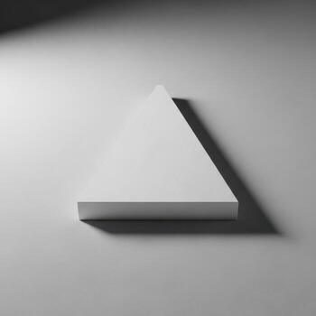 A minimalist geometric triangle shelf casting a sharp shadow on a clean white background isolated on white background photo