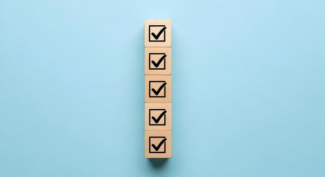 Wooden blocks with check marks on light blue background symbolizing checklist, goals, progress, and completion photo