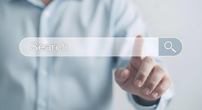 Person using index finger to touch a search bar on a digital screen The search bar is transparent and has a magnifying glass icon The concept is about internet search, exploration, discovery and techn photo