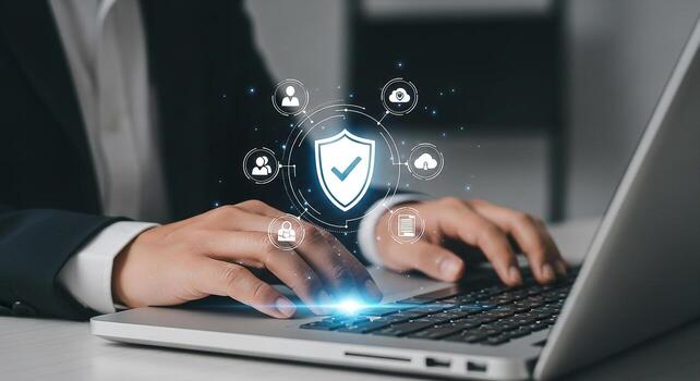 Businessperson working on laptop implementing cybersecurity measures ensuring data protection and privacy in modern office Image depicts digital shield cloud security and user privacy icons photo