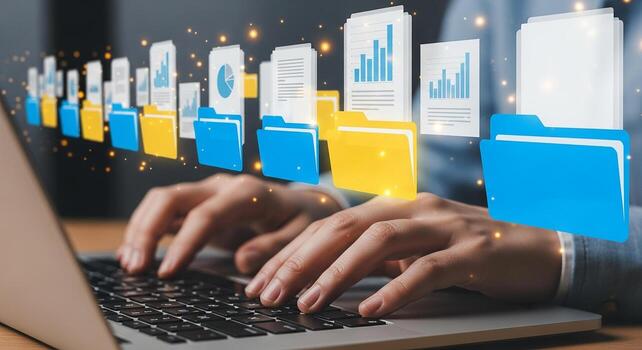 Person managing digital files and documents using a laptop computer at a desk showcasing efficient data organization and workflow for business or personal use The image evokes feelings of productivity photo