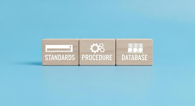 Wooden blocks with icons and text representing standards procedure and database on a light blue background This image symbolizes the essential elements of a structured and organized system highlightin photo