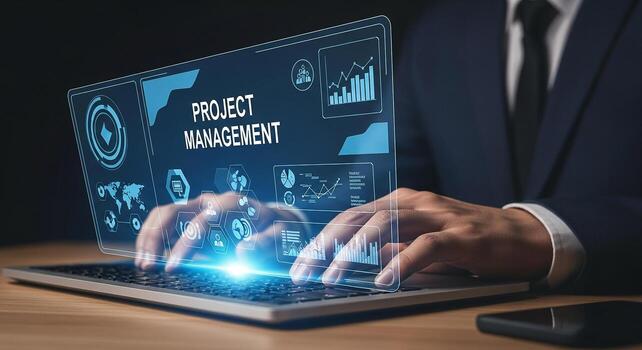 Businessman using laptop computer to manage projects in a modern office demonstrating effective project management and digital technology photo