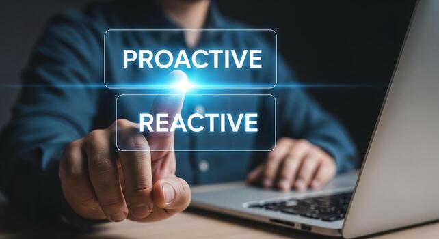 Man making a choice between proactive and reactive options on a laptop signifying decision-making and strategic planning in a modern workplace photo