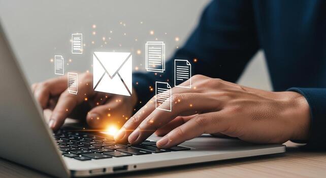 Person sending emails and documents using a laptop, working remotely from a modern home office, showcasing digital communication and connectivity photo