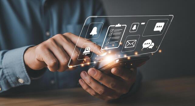 Person using smartphone to manage notifications, emails, and messages in a modern workspace, representing efficient communication and digital workflow photo