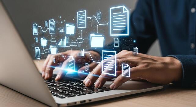 Person managing digital documents and data flow on laptop, working on a modern desk in a bright office, concept of efficient workflow and data organization photo