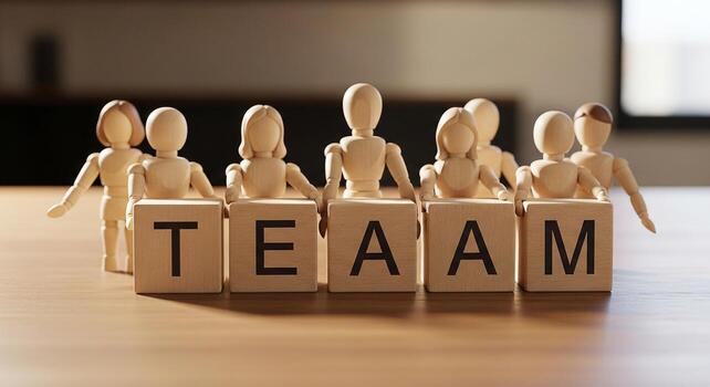Wooden figurines collaboratively presenting the word TEAM on a table, symbolizing unity, cooperation, and collective success in business and teamwork photo