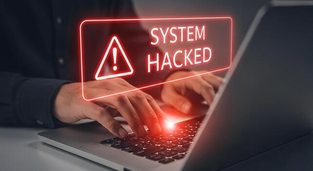 Person using laptop computer system hacked alert warning message on screen cybersecurity data breach digital crime concept image photo