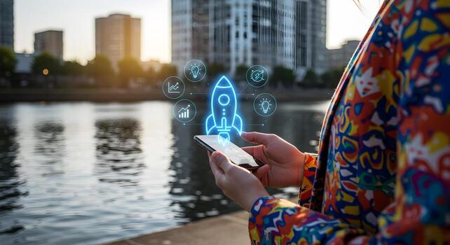 Woman using smartphone app with rocket launching interface symbolizing a new business startup standing by a river in a modern city at sunset The image conveys innovation progress and ambition in a vib photo