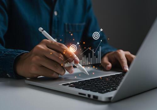 Person working on laptop computer analyzing data graphs and charts achieving business goals in a modern office setting The image conveys a sense of progress success and strategic planning photo