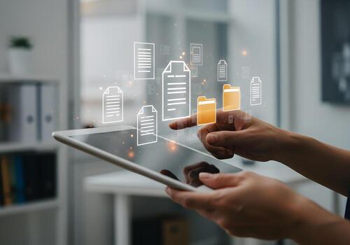Person using digital tablet managing files and folders in a modern office concept of digital document management and cloud storage photo