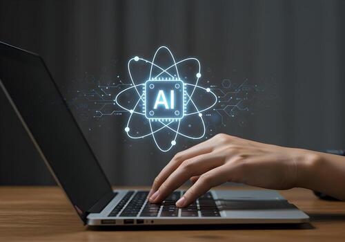 Person using laptop computer working with AI atom symbol technology innovation future digital transformation artificial intelligence modern workplace desk night dark background glowing bright illumina photo