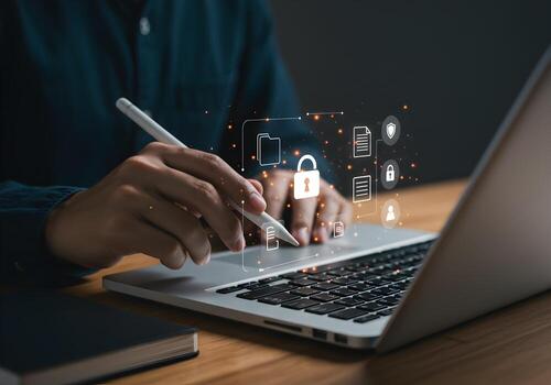 Person working on laptop computer at night securing digital files and information with a stylus Cybersecurity data protection privacy and digital safety concept photo
