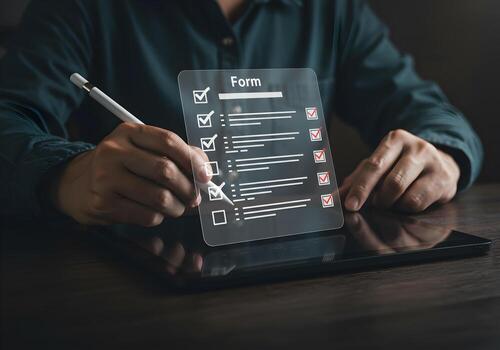 Person completing a digital checklist form on a tablet working diligently at a desk in a modern office setting signifying progress and efficiency photo