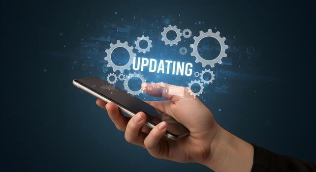 Hand using smartphone to update software gears and data graphics interface progress concept digital technology photo