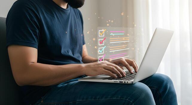 Man working on laptop at home checking tasks from a digital checklist achieving goals and productivity concept photo